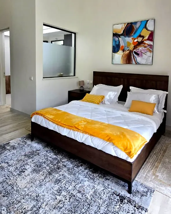 4-bedroom townhouse bedroom with wooden flooring and modern furniture in Limuru Town, Kenya